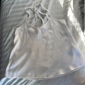 All white blouse with crossed straps.